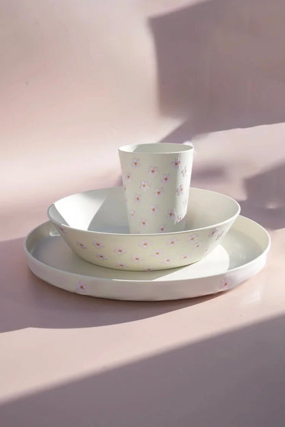 Selection of truck blooming flower prints of plates cups and bowls.