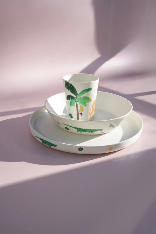 Selection of palm tree sticker prints of plates cups and bowls.