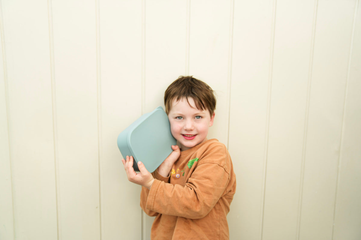 Kid holding lunch box