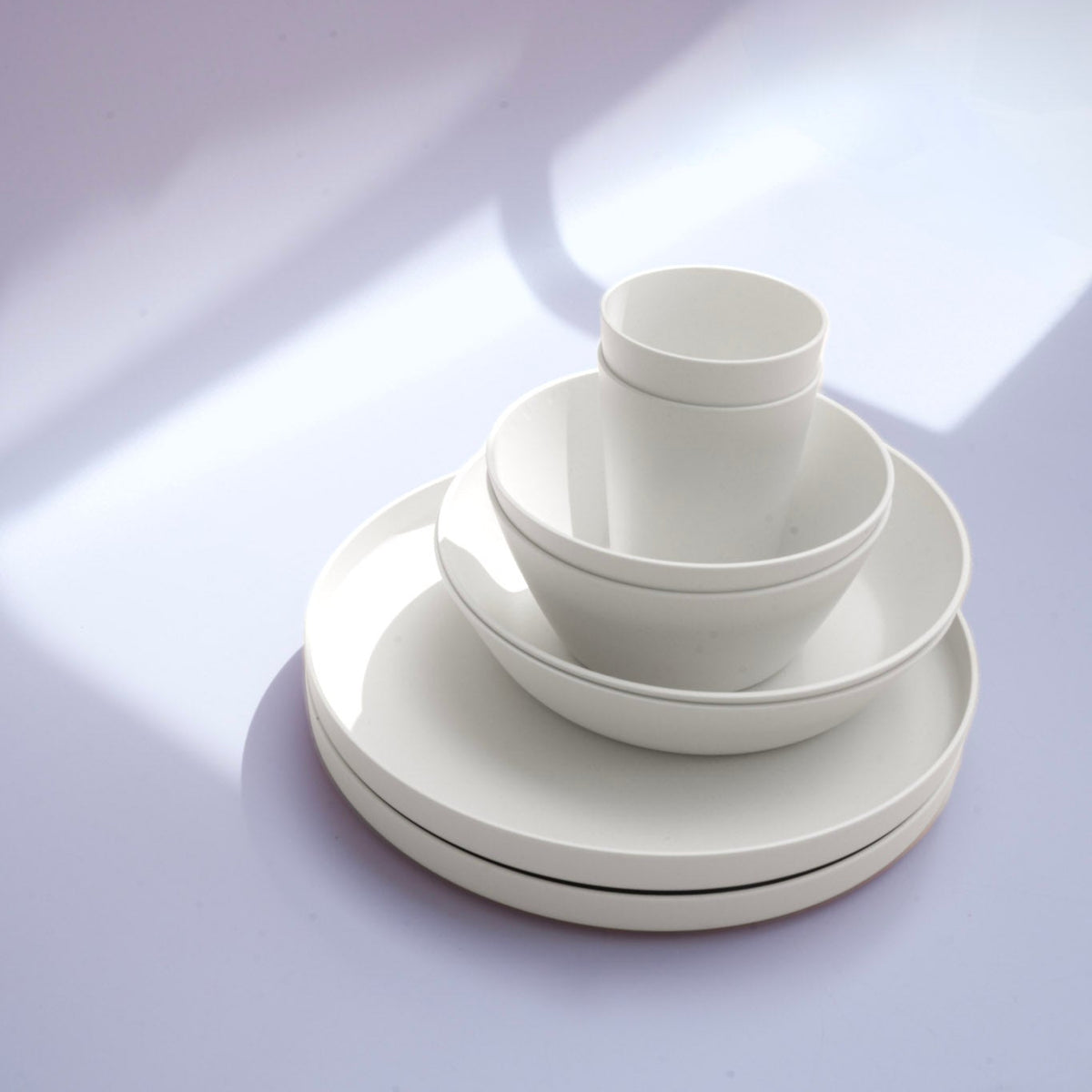 White set of plates, cup and bowls in an elegant design.