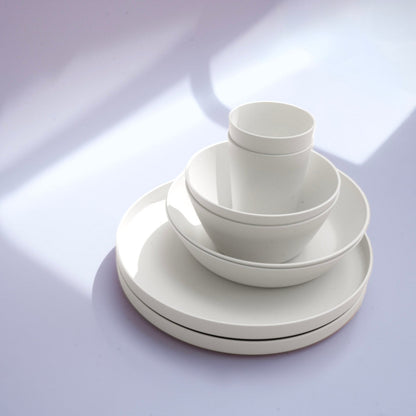 White set of plates, cup and bowls in an elegant design.