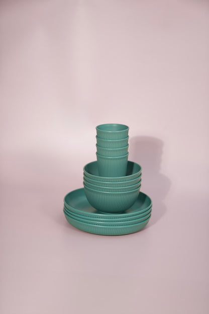 Green set of wheat straw bowls cups and plates in a practical design.