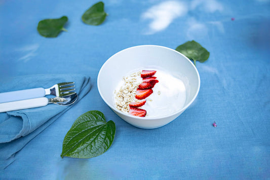 white plant based bowl with yoghurt and strawberries 