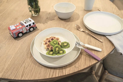 white dinnerware bowl plate and cups on a timber table with kids toy fire truck