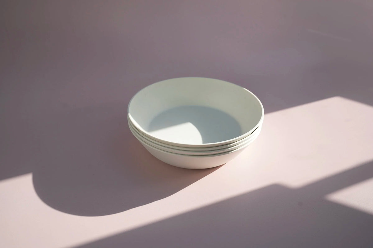 set of four white large bowls with shadow lighting