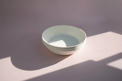 set of four white large bowls with shadow lighting