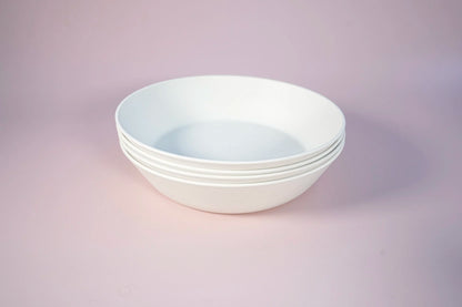 white bowls in a set of four on a pink background