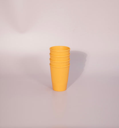 Stack on yellow plant based cups.